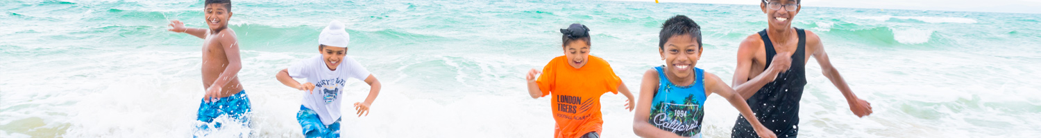 Boys running out of the sea